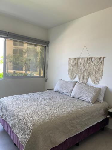 ein Schlafzimmer mit einem großen Bett mit Kronleuchter in der Unterkunft Bluu Habitat Lagoons En Mazatlan DEPARTAMENTO in Mazatlán