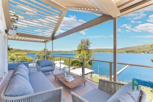 a living room with a view of the water at Central Coast Moon Lake Resort in Green Point