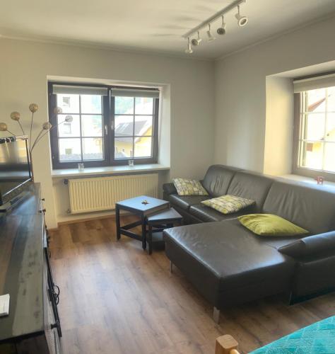 a living room with a couch and a table at Apartment an der Mühle in Mühldorf