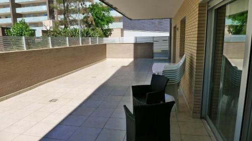 a patio with chairs and a balcony with a building at Saval Spa Aqquaria Family Complex in Salou
