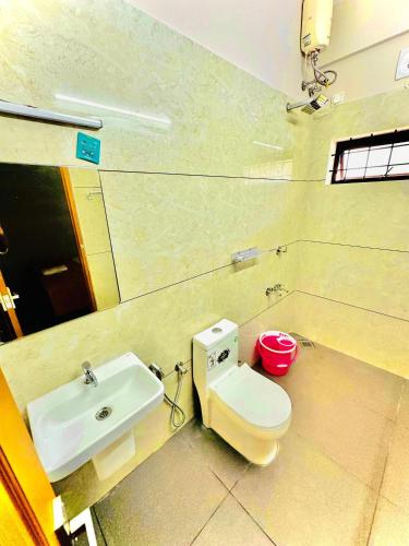 a bathroom with a toilet and a sink at Malabar Service Apartments in Cochin
