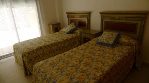 a hotel room with two beds and a window at Saval Spa Aqquaria Family Complex in Salou