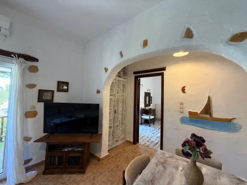 a living room with a tv and a table at Atlazia Suites in Alinda