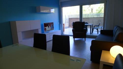 a living room with a couch and a table with chairs at Saval Spa Aqquaria Family Complex in Salou