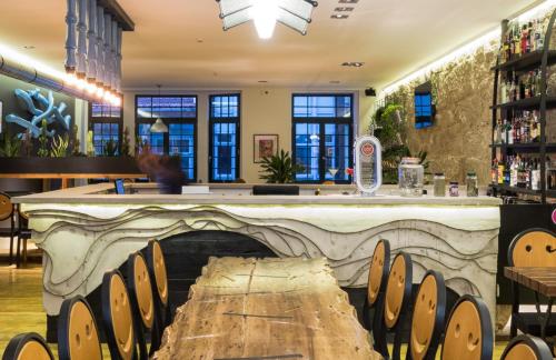 a bar in a restaurant with a stone counter top at Nice Way Porto Hostel in Porto