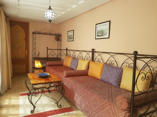 a living room with a couch and a bed at Riad Dar Karima in Rabat