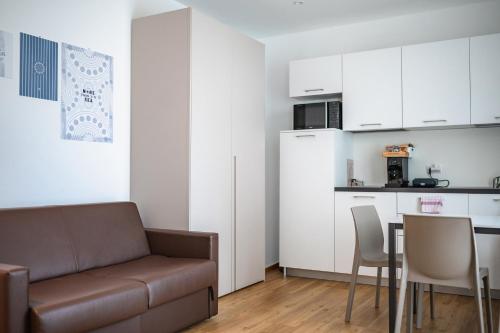 a living room with a couch and a table at Superior Beach Aparthotel in Lido di Jesolo