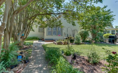 a garden with plants and trees in front of a house at Carrier Houses Bed & Breakfast in Rutherfordton
