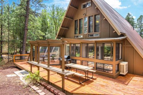 a house with a deck with a bench on it at Blissful Pine A-Frame Chalet Deck Game Room Mother-in-Law Suite Sleeps 16 in Mountainaire