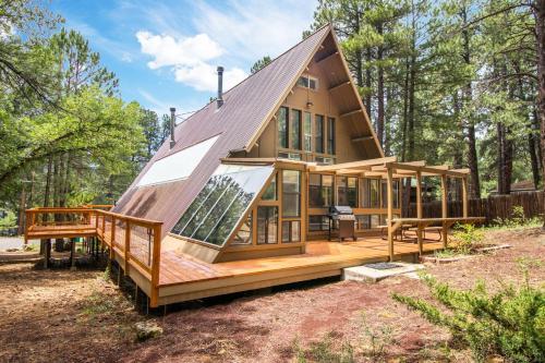 a home with a large deck and a house at Blissful Pine A-Frame Chalet Deck Game Room Mother-in-Law Suite Sleeps 16 in Mountainaire