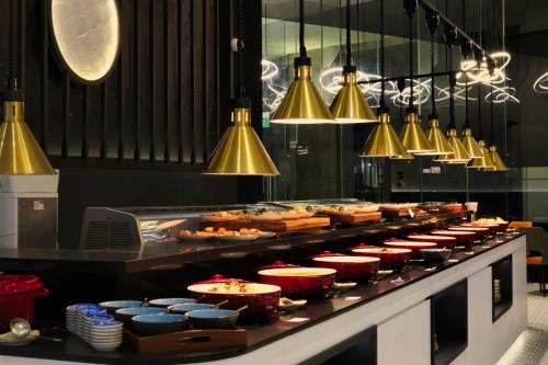 a buffet line of food in a restaurant at Dorsett Singapore - Newly Refurbished in Singapore