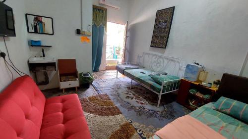 a living room with a couch and a table at Cassa Bonda Std Family Room in Machang
