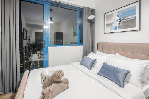 a bedroom with a bed with towels on it at Makati Penthouse Studio with City Views in Manila