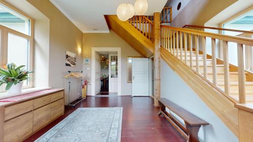 a hallway with a staircase and a stair case at Fáy Mansion in Irota