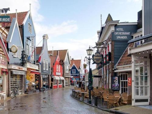 an empty street in a town with buildings at Houseboat in Volendam near Fort Edam in Volendam
