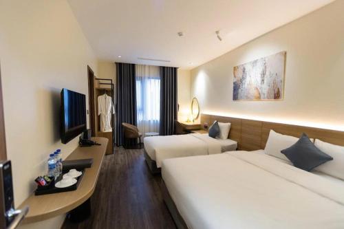 Postel nebo postele na pokoji v ubytování Chu Gia Hotel