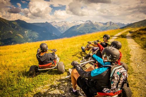a group of people riding on quad bikes on a mountain at Pension St.Leonhard in Bad Gastein
