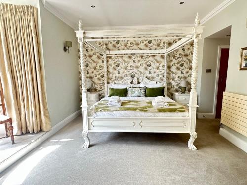 a bedroom with a white bed with a canopy at Luxury 2-bed stay, Rooftop Terrace, Hot tub, By Cruise Terminal, Oxford Street in Southampton