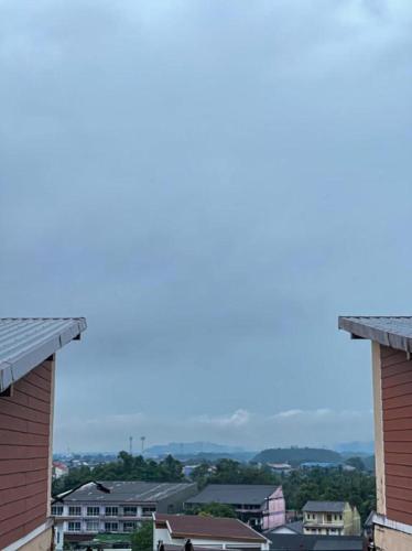 a view of a city from between two buildings at Rueangrat Hotel in Ranong