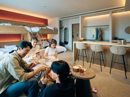 a group of people sitting in a living room at FAV LUX Sapporo Susukino in Sapporo