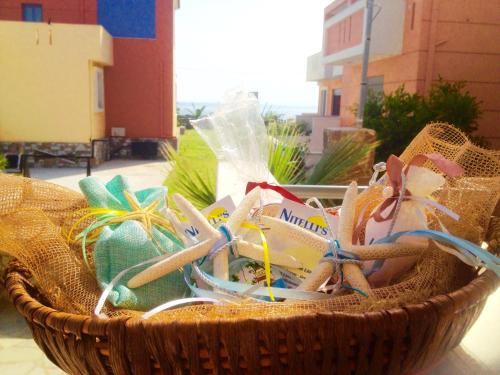 a basket filled with easter eggs and bows at Nitelli's Houses in Skála Néon Kydonión