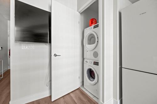 a laundry room with a washer and dryer at Charming Studio in Downtown Toronto in Toronto