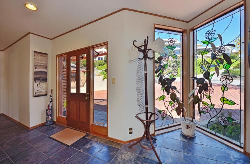 a home entry with a glass door and a plant at The Cliffs - Nelson Waterfront Home in Nelson