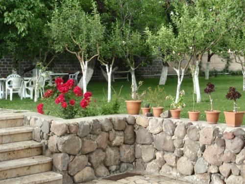 a retaining wall with a bunch of flowers at Chez Yvette in Garni
