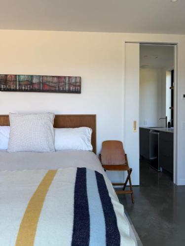 a bedroom with a bed and a desk and a chair at Coronet View Chalet in Frankton Wharf