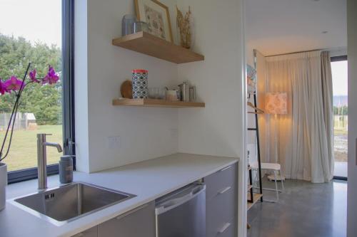 a kitchen counter with a sink and a window at Coronet View Chalet in Frankton Wharf