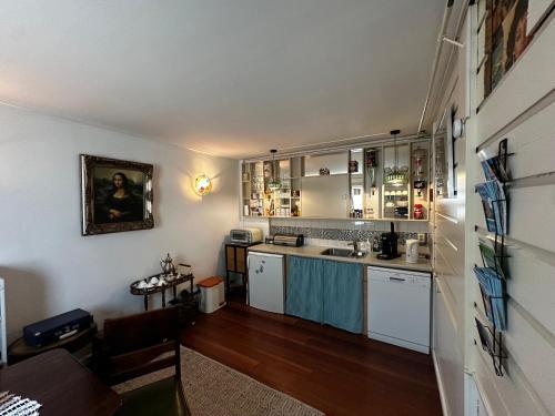 a kitchen with white cabinets and a counter top at Het Kraaienest in Zaandam
