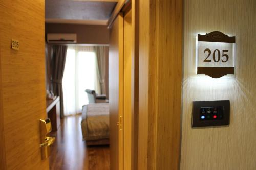 a room with a door with a sign that reads at Lale Hotel in Sapanca