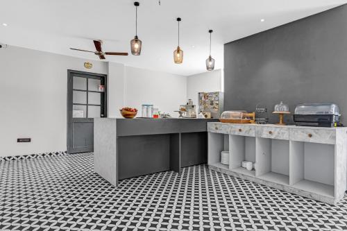 a kitchen with black and white tiles on the floor at SaffronStays Sukh Saklana Haveli Suites in Rishīkesh