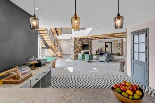 a living room with a bowl of fruit on the floor at SaffronStays Sukh Saklana Haveli Suites in Rishīkesh