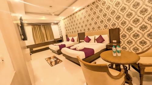 a hotel room with a bed and a table at Hotel Almora BY The ELEVATE Group Near Delhi INTERNATIONAL Airport WIth- Free AIRPORT Pickup in New Delhi