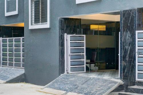 an open door to a building with a glass doorway at Collection O Hinjewadi in Pune