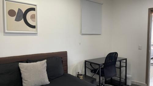 a bedroom with a bed and a desk with a chair at Center City Flats - Apartments in El Poblado near Park Lleras, Medellin! in Medellín