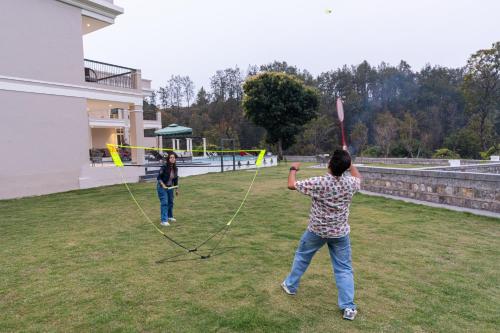 two people are flying kites in a yard at SaffronStays Sukh Saklana Haveli Suites in Rishīkesh