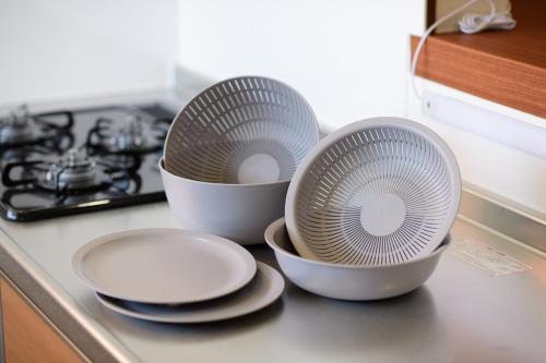 three bowls and plates sitting on a kitchen counter at 小由る木 in Odawara