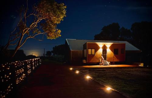 a small house with lights in front of it at night at The Tiny Apostle - Great Ocean Road in Princetown