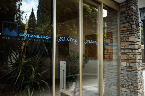 a glass door with the words welcome on it at Götznerhof - Self-Check-in in Innsbruck