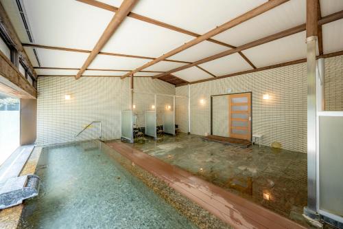 an empty room with a pool of water at Southern Cross Resort in Ito