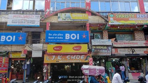 a bunch of signs on the side of a building at Hotel Shristy Residency in Dhanbād