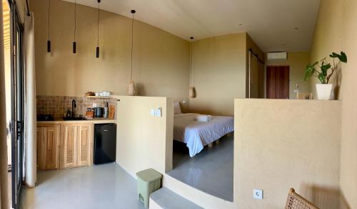 a small kitchen with a table in a room at Jepun Hill Studios & Amed Jepun Divers in Amed