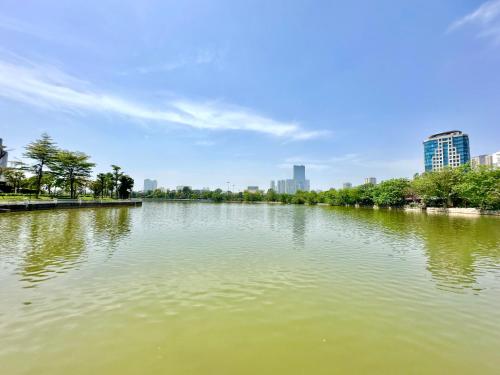a view of a river with a city in the background at 5 Star Apt Studio, Swimming Pool, Gyms, Quick To Airport in Hanoi