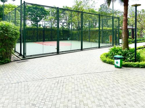 a tennis court with a gate with a tennis racket at 5 Star Apt Studio, Swimming Pool, Gyms, Quick To Airport in Hanoi