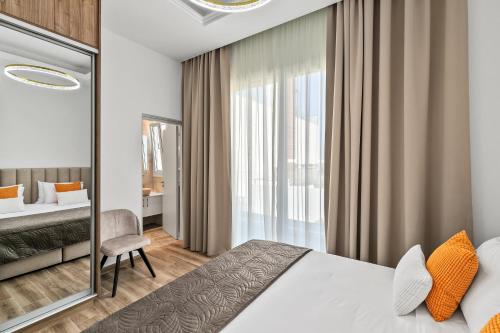 a hotel room with a bed and a chair at Olymp White Palace - The Ultra Luxury Beach House in Kissonerga