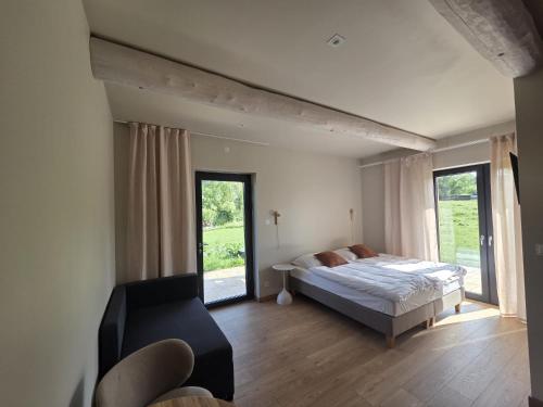 a bedroom with a bed and a large window at Szept Gór in Lutowiska