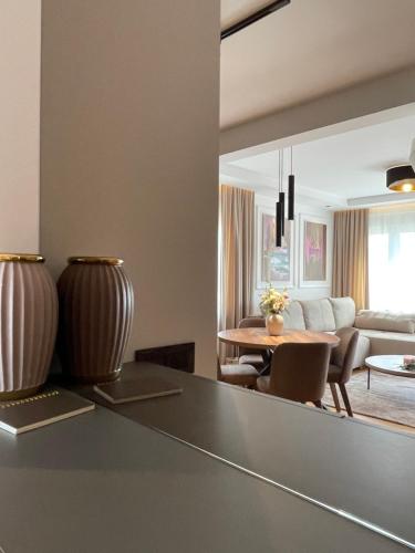 a living room with a table and a couch at Apartman Boutique Arandjelovac in Arandjelovac