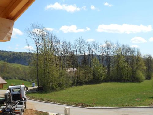 a truck parked on a road next to a field at Le chalet du lac d'étival in Étival